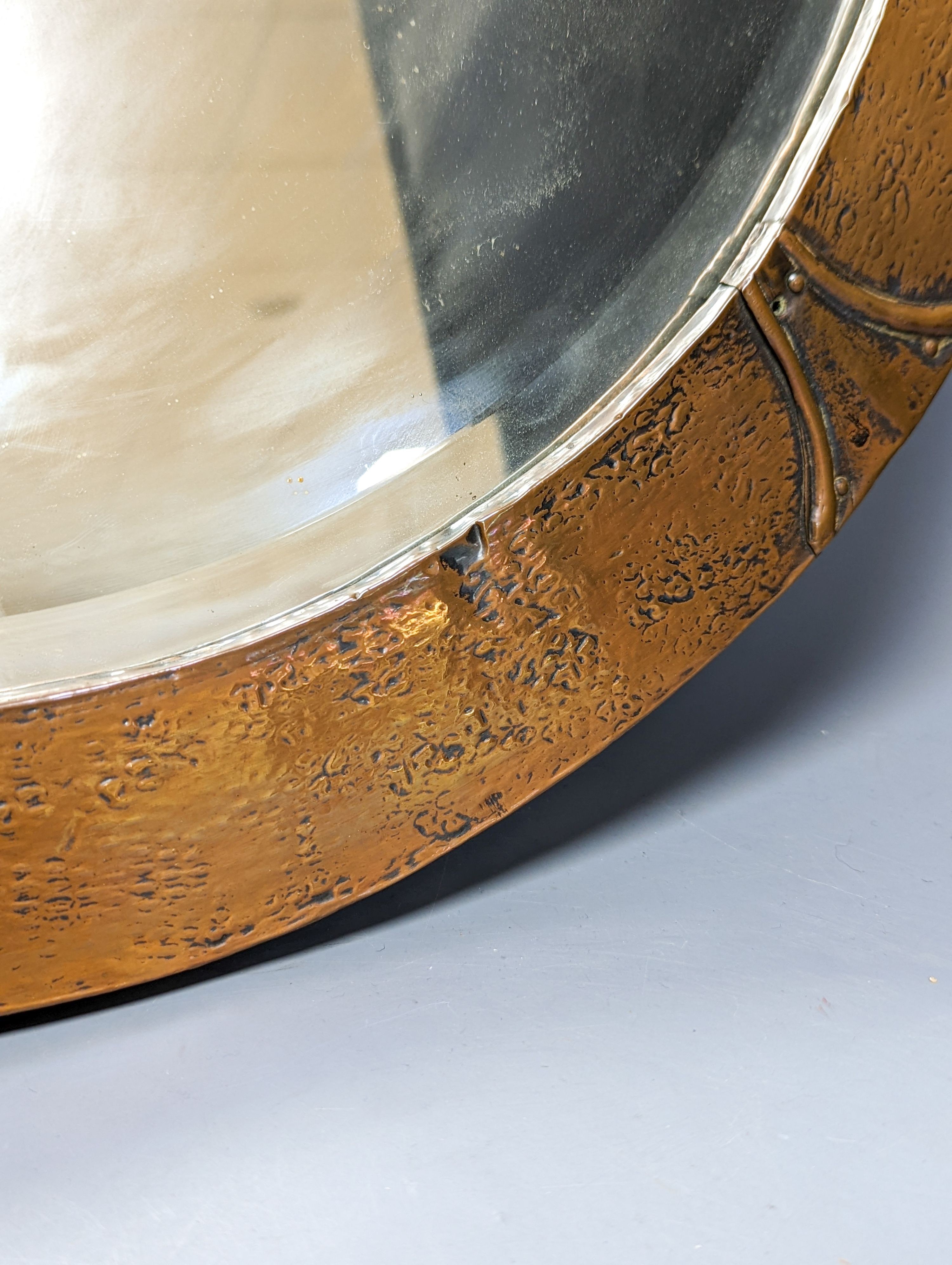 An Arts & Crafts circular copper mirror 56cm